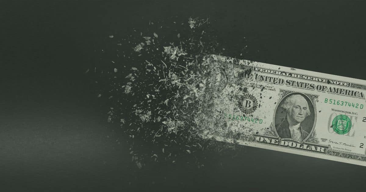 Picture of a dollar bill disintegrating, representing inflation.